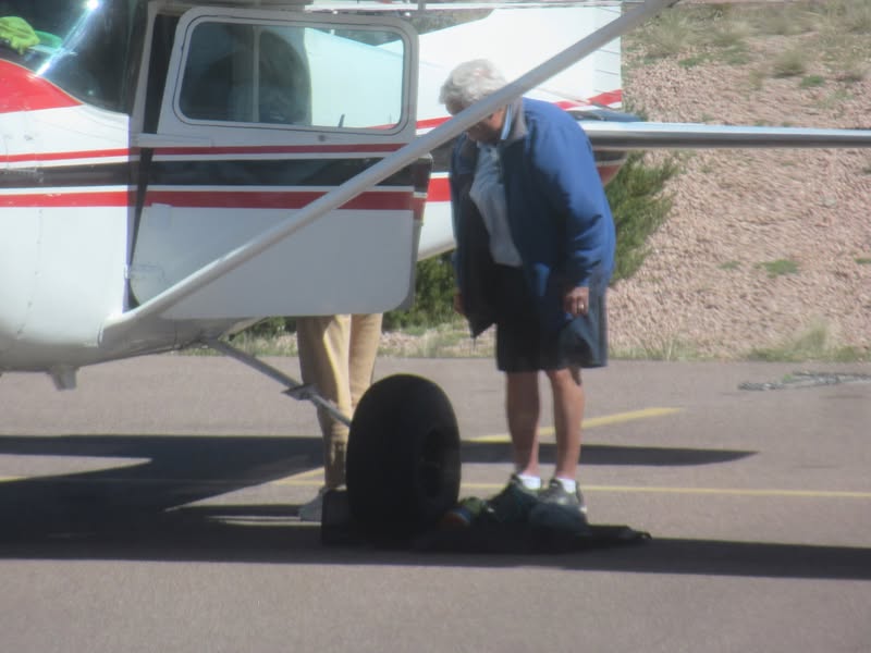 That must be Penny doing the preflight check on the escape door in case his flying isnt up to par.