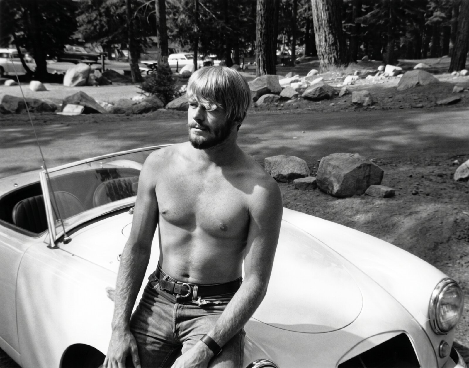A young Lanny Badten leaning against a car