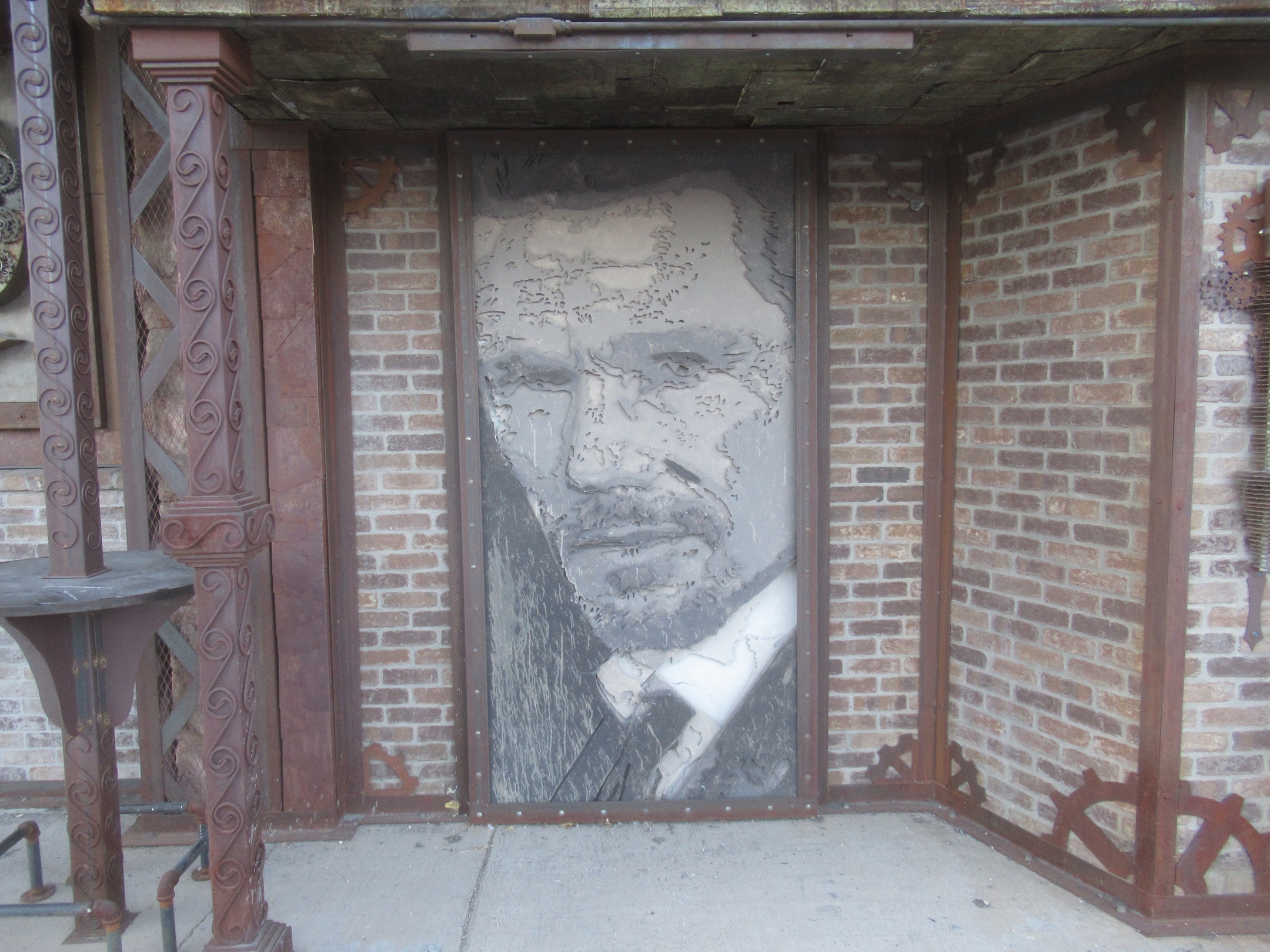 The metal cutout portrait that reveals a man's face from a distance