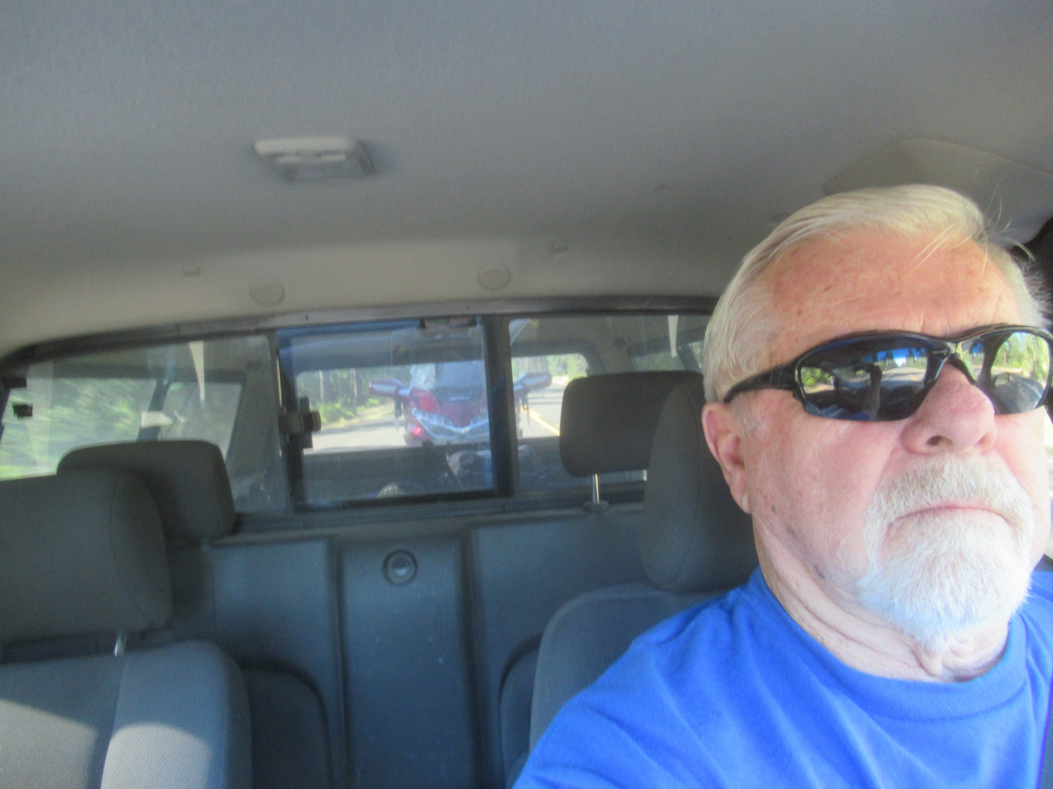 Riding along with the Gold Wing trailing behind, reflected in the rear window